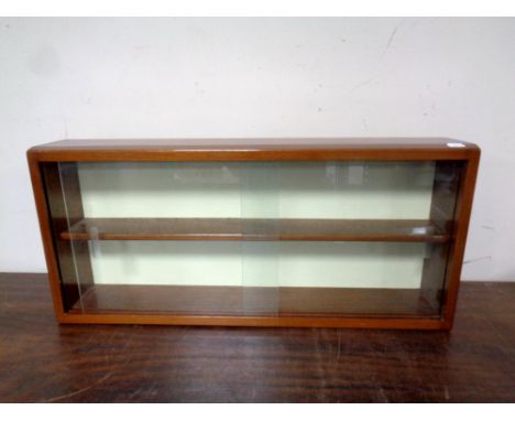 A teak sliding glass door wall shelf 