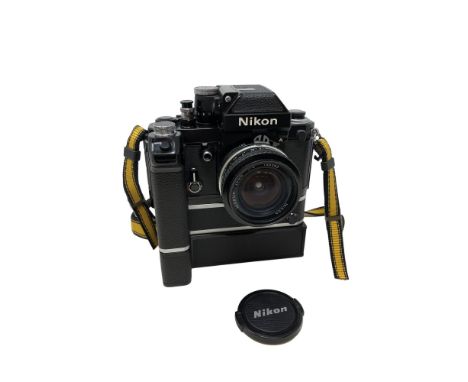 A Nikon F2 camera fitted with Nikkor 20mm 1:4 lens 136545, with Nikon motor drive MD-2 and MB-1. 