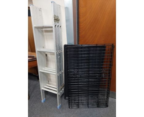 An extending aluminium ladder together with a folding metal pet cage 