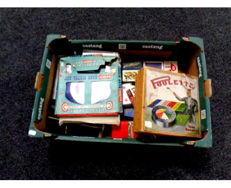 A box containing Poolette game, playing cards, vintage Mettoy metal pistol targets, other games etc 