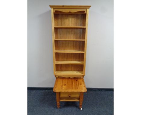 A set of wall mounted pine bookshelves together with a pine lamp table fitted a drawer  