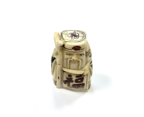 A Chinese bone netsuke - A Village Elder Holding a Scroll. 