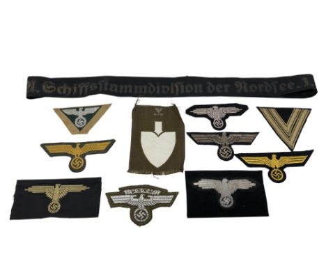 A Group of German cloth insignia, mostly eagle emblems including NSKK example, Reichsarbeitsdienst shoulder patch, naval cap 