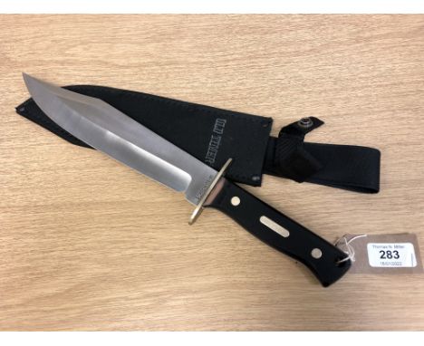 An "Old Timer" hunting knife, stamped "SCPROM-16-31", overall length including handle 39 cm, with sheath. 