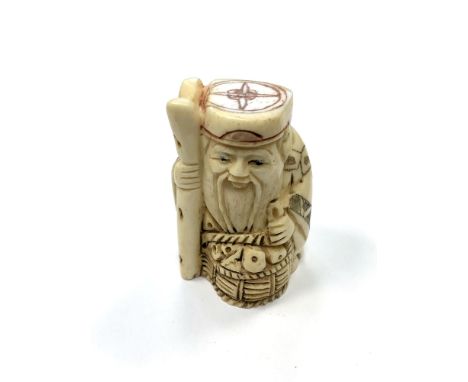A Chinese bone netsuke - A Village Elder with a Basket of Wares. 