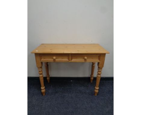 A stripped pine console table fitted two drawers 