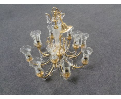 A decorative brass twelve branch chandelier with glass tulip shades and drops 