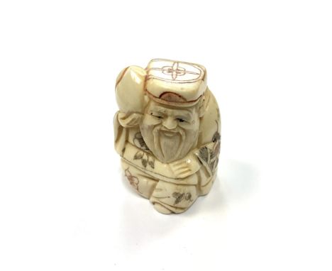 A Chinese bone netsuke - A Village Elder Carrying Fruit. 