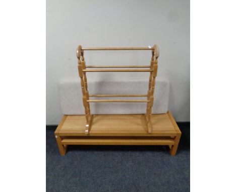 A contemporary oak bench with cushion and under shelf together with a towel rail  