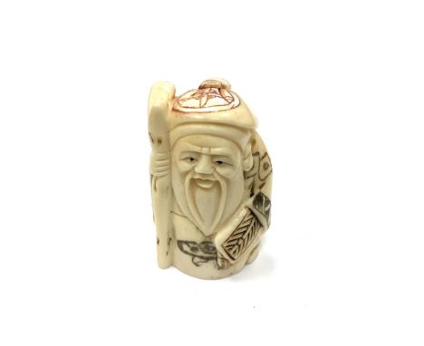 A Chinese bone netsuke - A Beaded Man Holding a Stick. 