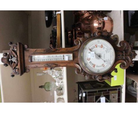A T Bassnet oak aneroid wheel barometer, incorporating a fahrenheit and centigrade thermometer
