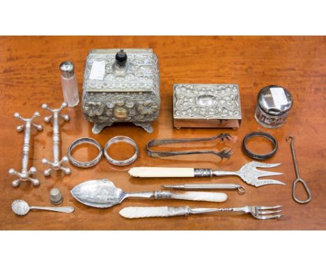 A plated vesta box, an EPNS single tea caddy, perfume bottle, a pair of small silver napkin rings, pair of knife rests, mothe