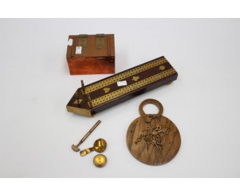 An Arts & Crafts style copper and brass small box, hinged/strapped lid, a mahogany and brass cribbage board 19th century, a d