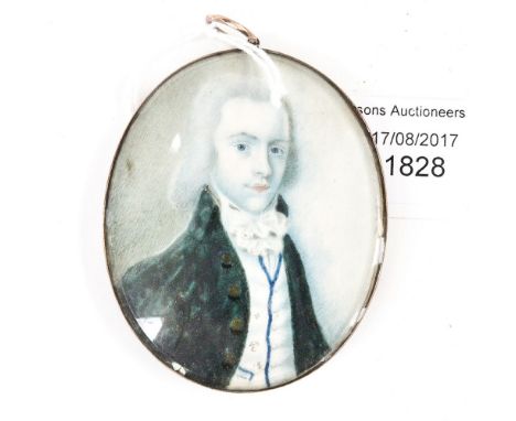 A George III oval portrait miniature, bust of a young gentleman wearing a green button tunic, lock of hair and monogram verso