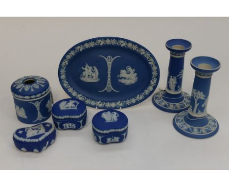 A Wedgwood Jasperware blue ground dressing table set, comprising a pair of candlesticks, an oval dish, with a collection of t