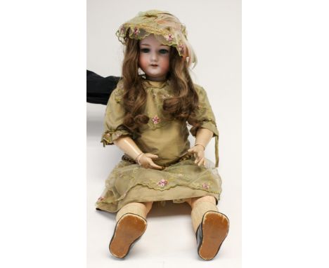 Armand Marseille: An Armand Marseille bisque head doll, deep blue eyes, long brown human hair, body appears in good condition