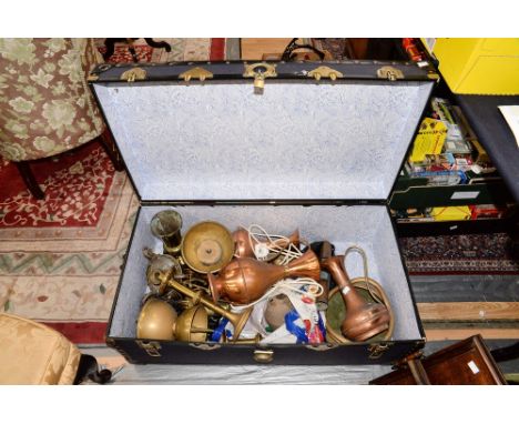 A school boys trunk containing an ecclesiastical collection of brass and copper bowls, vases and candlesticks 