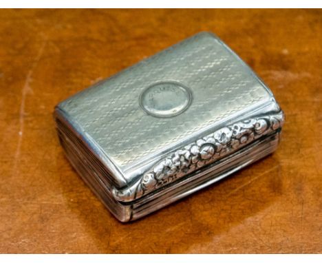 A George III silver snuff box, cushioned chest form, engine turned stripe with cast floral thumb piece, gilded to the interio