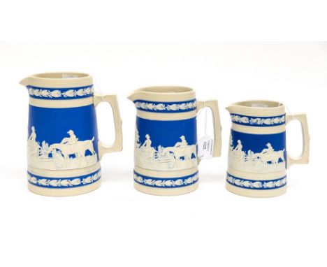 A graduated set of three Copeland jugs, circa 1884 with applied hunting scenes, horses, hounds, etc (middle jug has chip to l