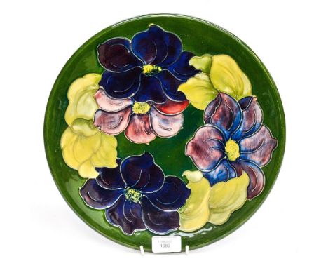 A Moorcroft Limited Edition 172/200 charger, made in 1982, initialed WM to base 'Clematis' pattern on green ground, measuring