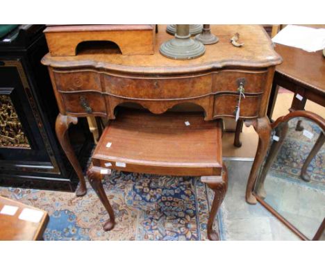 An early 20th Century Queen Anne style walnut dressing table, fitted with a long drawer and two small drawers, raised on cabr