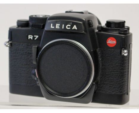 Leica: A Leica R7 matte black camera body, serial number 1911911, generally good, shutter working, boxed with instructions.