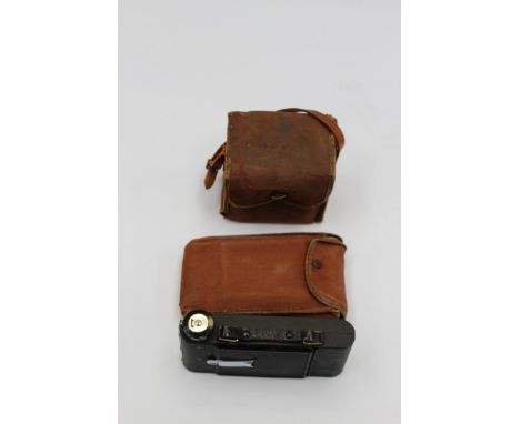 A Robi 1.11 F.10.5 camera and casing, together with an expanding Penguin Kershaw 8-20