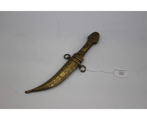 An Arabian dagger, brass and iron with a small polished ruby embedded into the curved blade 