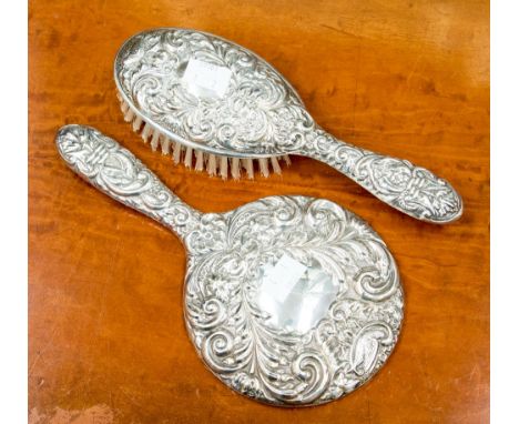 A silver backed hand mirror and brush, Birmingham 1980 and 1982 (2) 