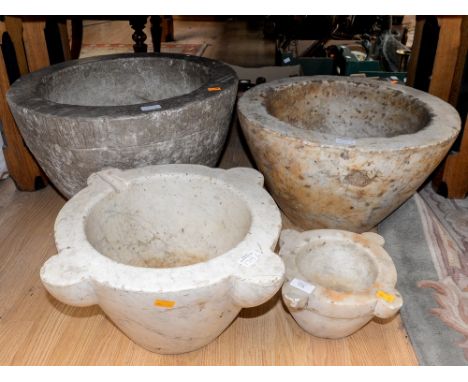 A collection of four marble and stone mortars, including a large sedimentary planter with fossils (4)