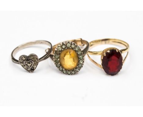 A yellow metal (probably 18ct) and red stone dress ring, size P1/2 along with a 9ct gold and silver dress ring set with a yel