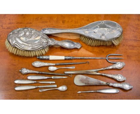 A group of silver handled ladies accoutrements including brushes, button hooks glove stretcher, nail files etc 
