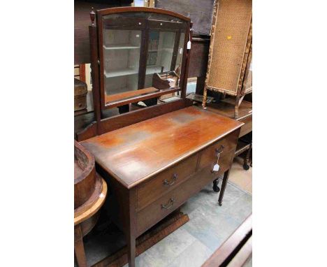 An Edwardian mahogany dressing chest, having a mirror to back, comprising two short drawers and one long drawer