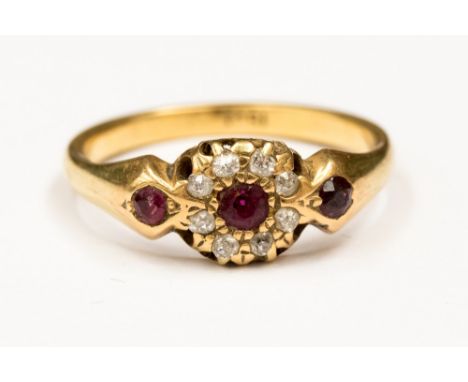 A ruby and diamond 18ct gold (stamped) Victorian cluster ring, set with a central rubies, with a diamond surround and ruby se