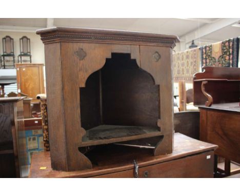 A Gothic Revival oak floor standing corner shelf, low level shelf