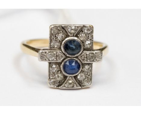 An Art Deco sapphire and diamond set 18ct gold ring, with a rectangular head set with two rub-over set blue sapphires with gr
