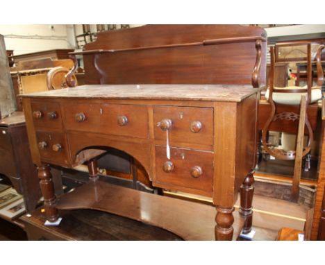 A mid Victorian mahogany dressing table, fitted with an upper shelf section, four short drawers and a long central drawer, ra