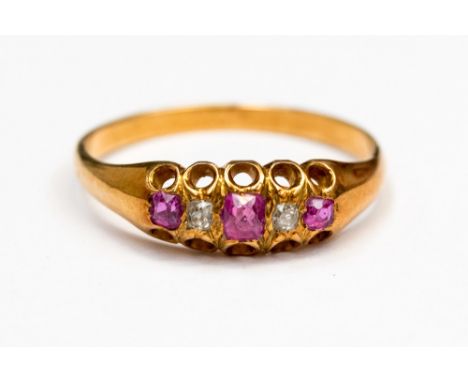 A Victorian diamond and pink sapphire ring set in rose metal, with three pink sapphires and two old cut diamonds, ring size K