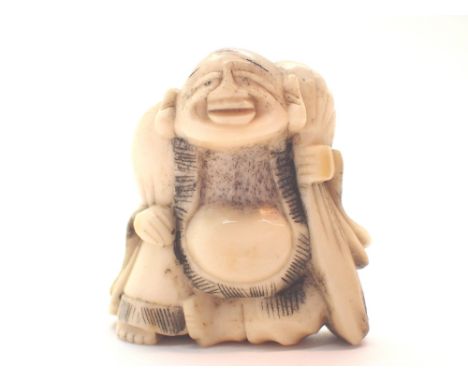 Antique bone Netsuke of a God