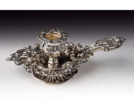 A silver chamber candlestick. Italy, end of the 19th Century. Measures&nbsp;: lenght cm 19 ca; g 135 ca. Minor defects. 