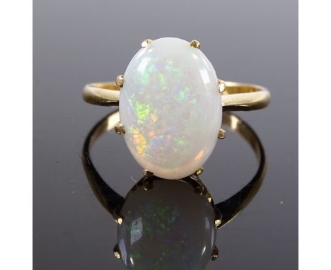 An unmarked gold cabochon opal ring, setting height 12.6mm, size N, 2.8g