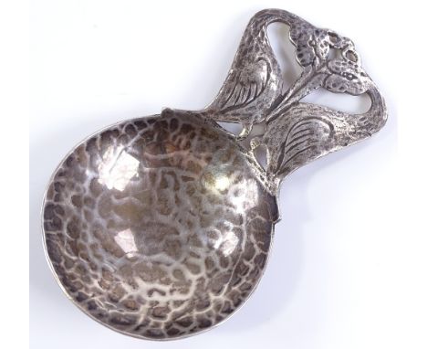 An Arts and Crafts silver caddy spoon, with Egret bird handle and circular hammered bowl, by Bernard Instone (Langstone Silve