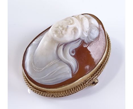 A high relief carved cameo brooch, depicting female portrait bust, in 9ct gold rope twist frame, brooch height 43.1mm, brooch