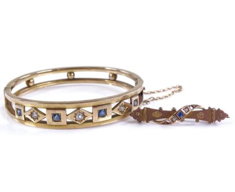 An Edwardian unmarked gold sapphire and diamond open work hinged bangle, bangle height 11.1mm, internal diameter 54.1mm, 14.3