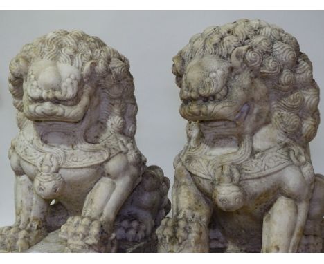 An impressive pair of large scale Chinese carved stone ornamental Dogs of Fo, probably alabaster, on ornate carved plinth bas