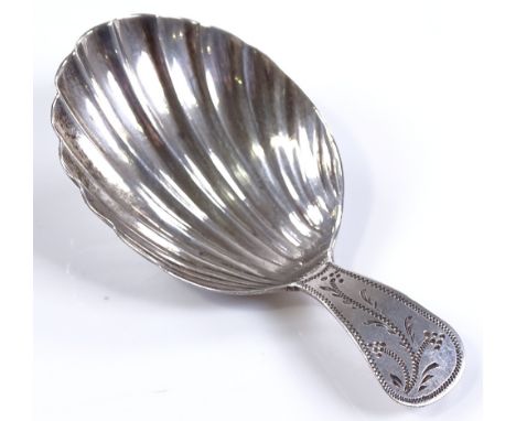 A small silver tea caddy spoon, with a shell shaped bowl and a bright-cut floral handle, indistinct marks, length 6.5cm 