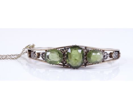 An unmarked green stone and seed pearl hinged bangle, maker's marks RL, setting height 14.1mm, internal diameter 55mm, 18.8g