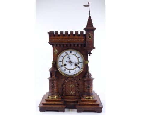 A 19th century German oak-cased mantel clock in the form of a castle, enamel dial and 8-day striking movement by Junghans, ov