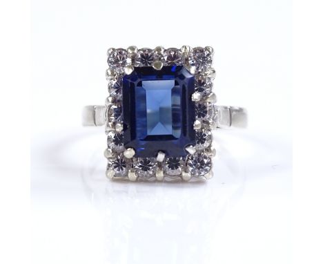 An 18ct white gold synthetic sapphire and CZ cluster ring, setting height 15mm, size R, 5.7g