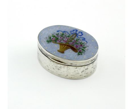 An Austrian silver and enamel pill box, oval form, the hinged cover enamelled with a basket of flowers, on a light blue groun